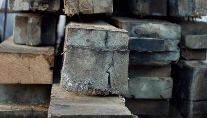 raw oak beams stacked and stored in our Hertfordshire reclamation yard