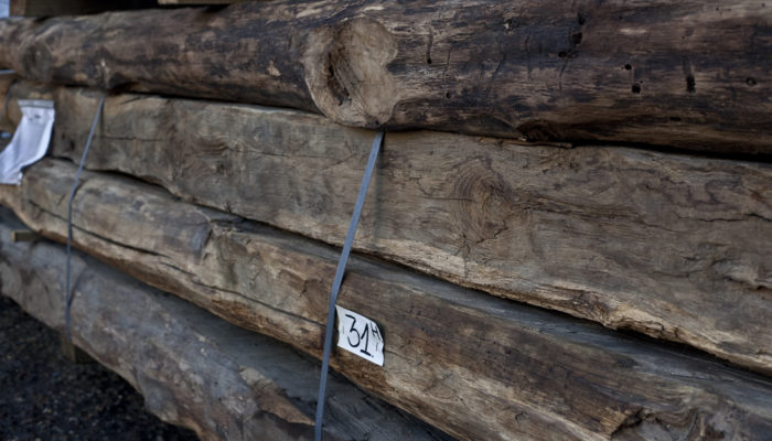 raw oak beams stacked and stored in our Hertfordshire reclamation yard