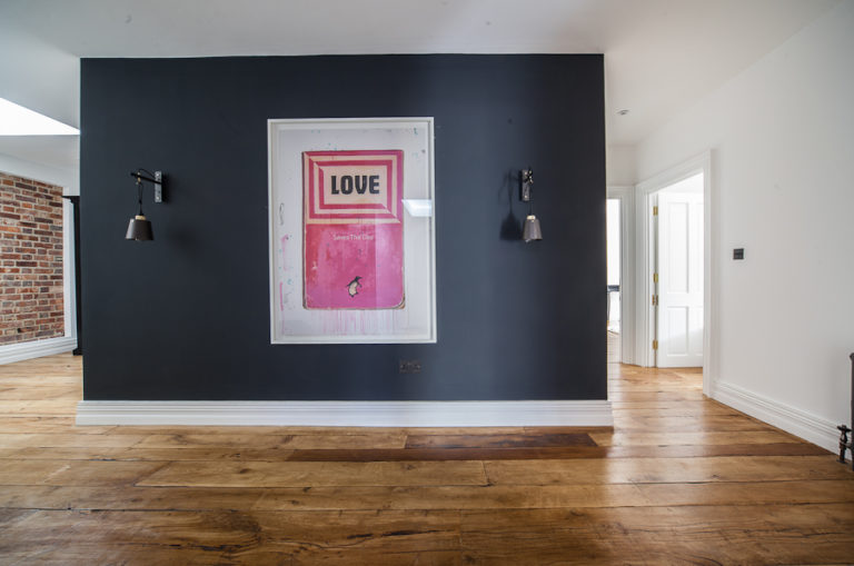 Wide angle view of hallway with central block, large poster on the wall