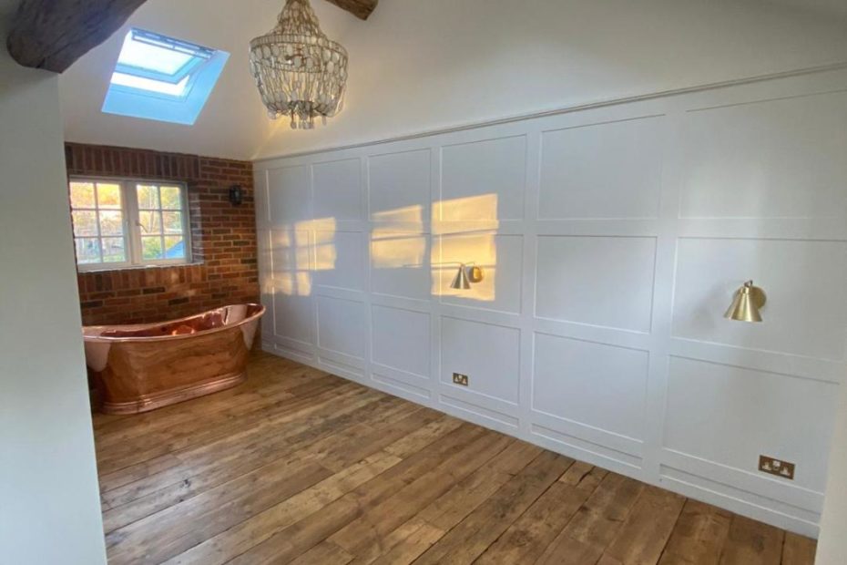 Reclaimed pine scaffold board flooring in situ with copper bath