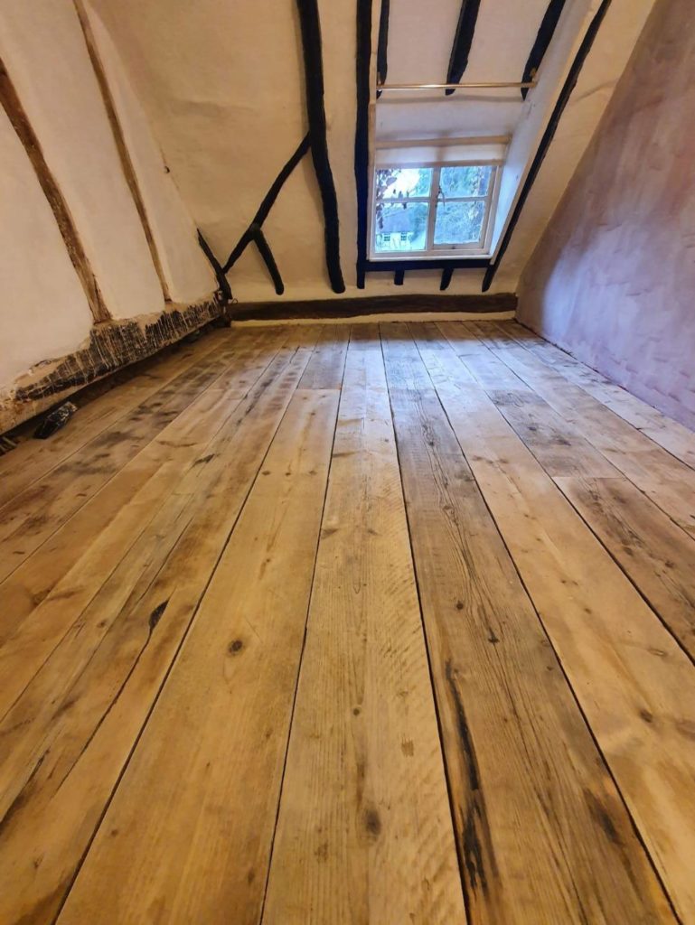 reclaimed pine scaffold board flooring in situ in a loft room